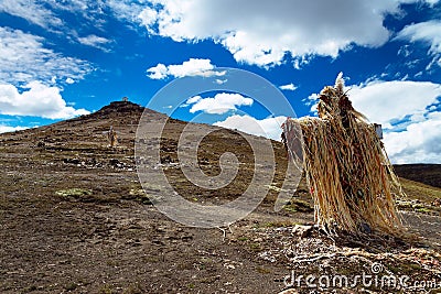 The decorated cross and the hill above Abra OquepuÃ±o in Andes, southern Peru Stock Photo